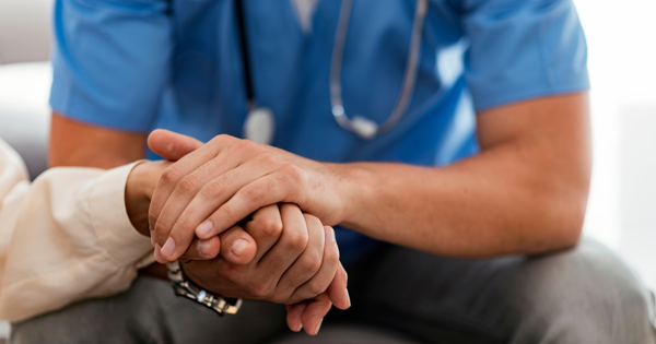 Doctor Holding A Patients Hand In Support