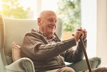 Older Man Sat On His Chair At Home