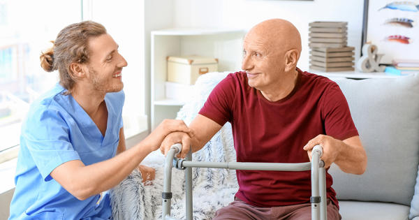 Man And Care Worker In Living Room Zimmer Frame