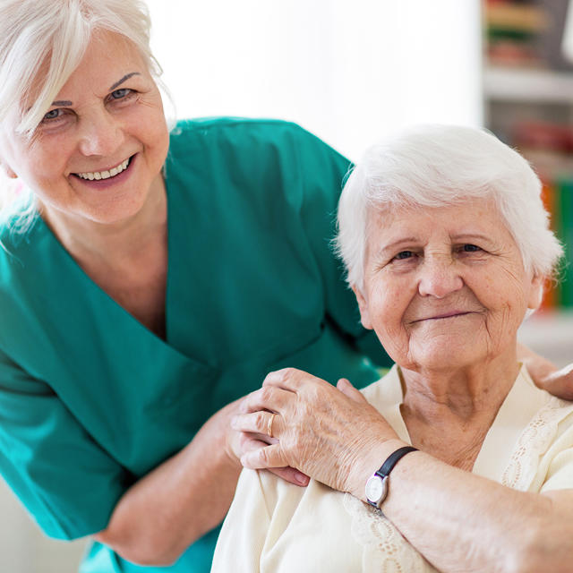 Carer Smiling With Older Woman