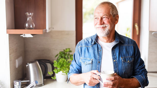 Man In Kitchen With Coffee Cup